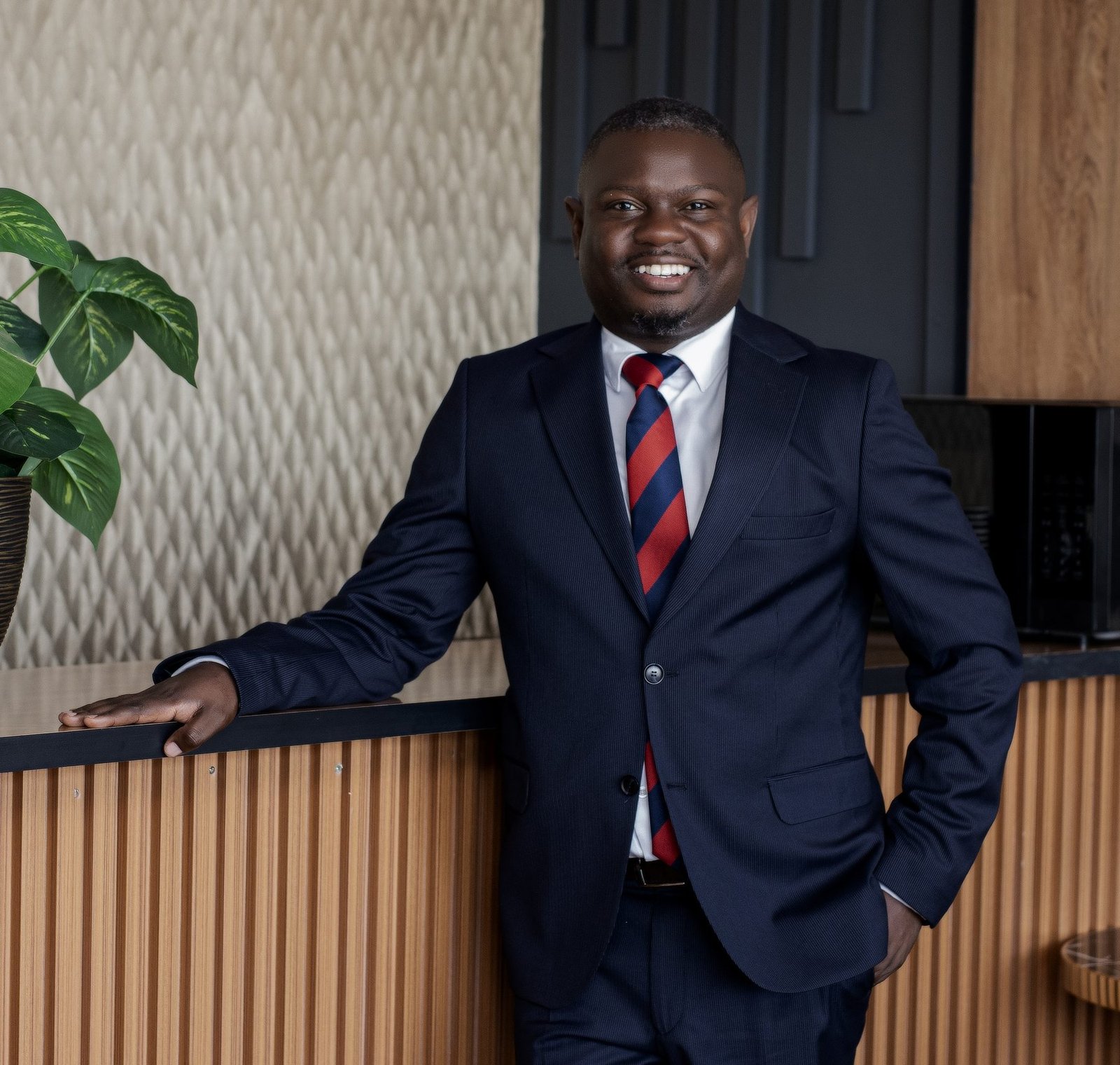 Executive smiling with a hand on a counter