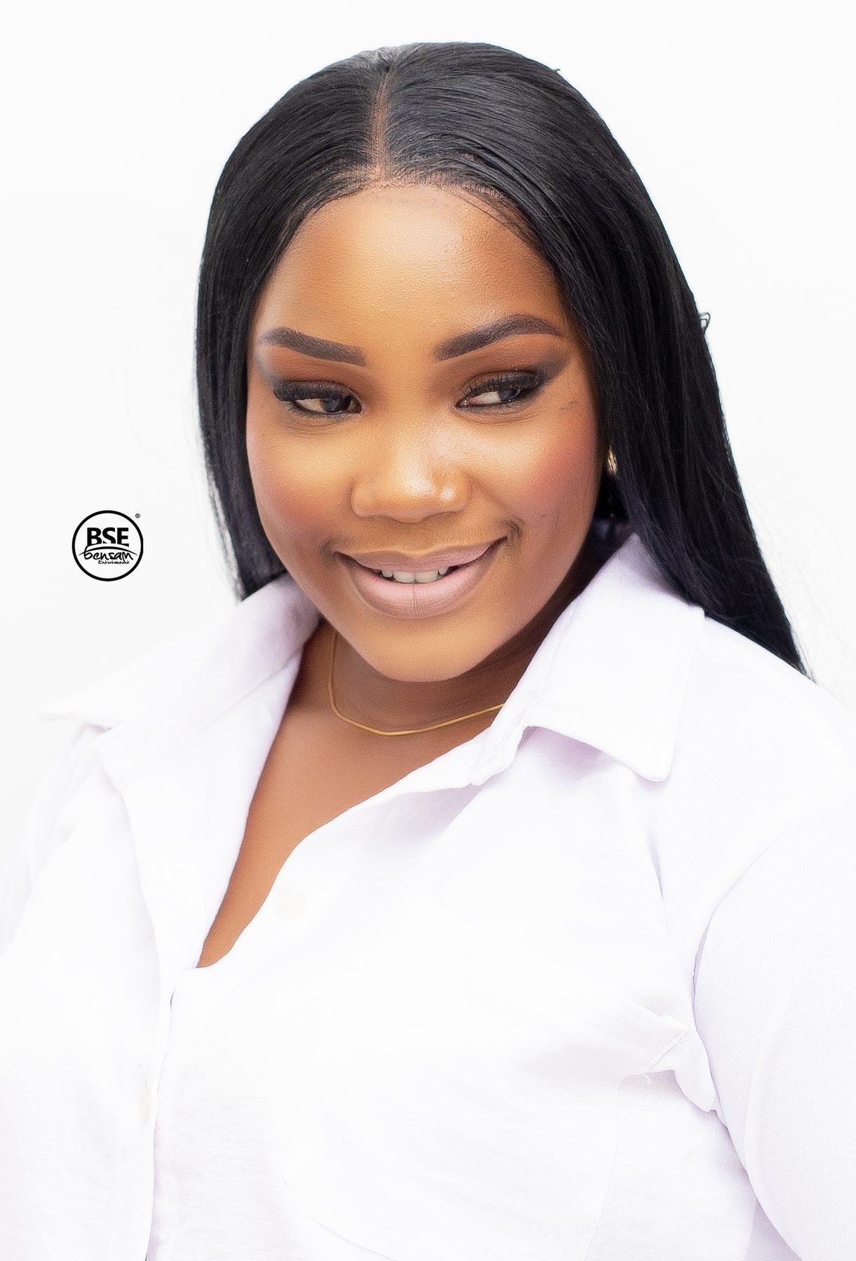 Studio headshot of a woman in a white shirt